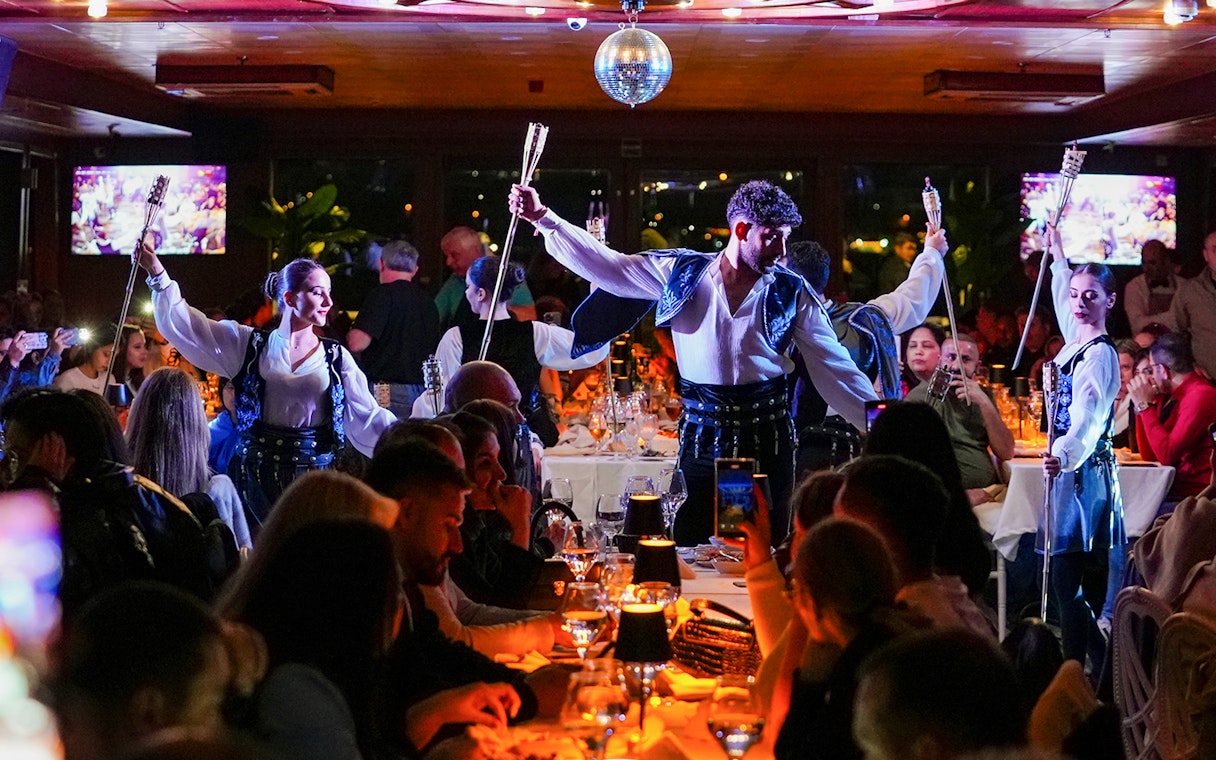 Dancers performing with torches during Bosphorus 4-Course Dinner Cruise, live entertainment.