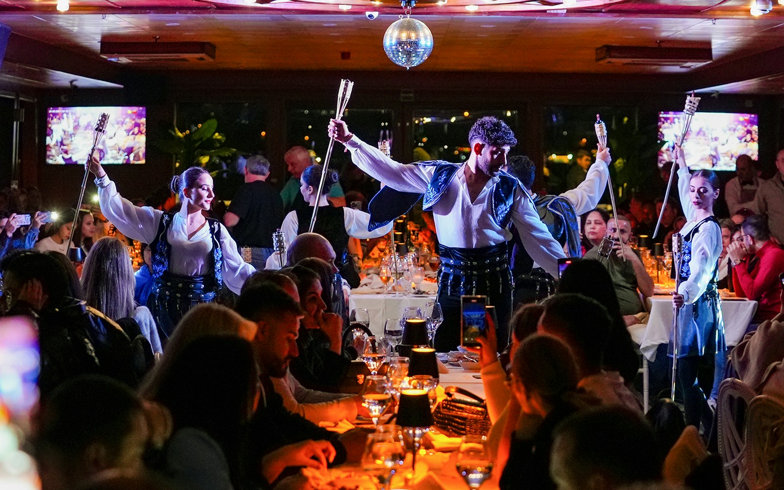 Bosphorus dinner cruise with live entertainment, Istanbul skyline in the background.
