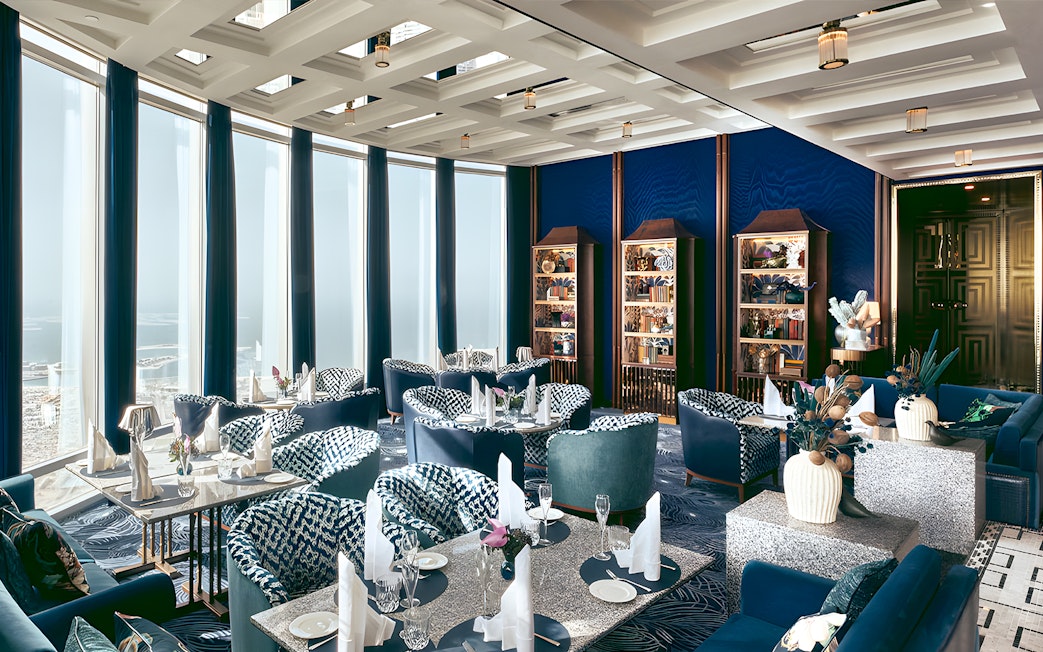 Dining area at At.mosphere Burj Khalifa with elegant seating and panoramic city views.