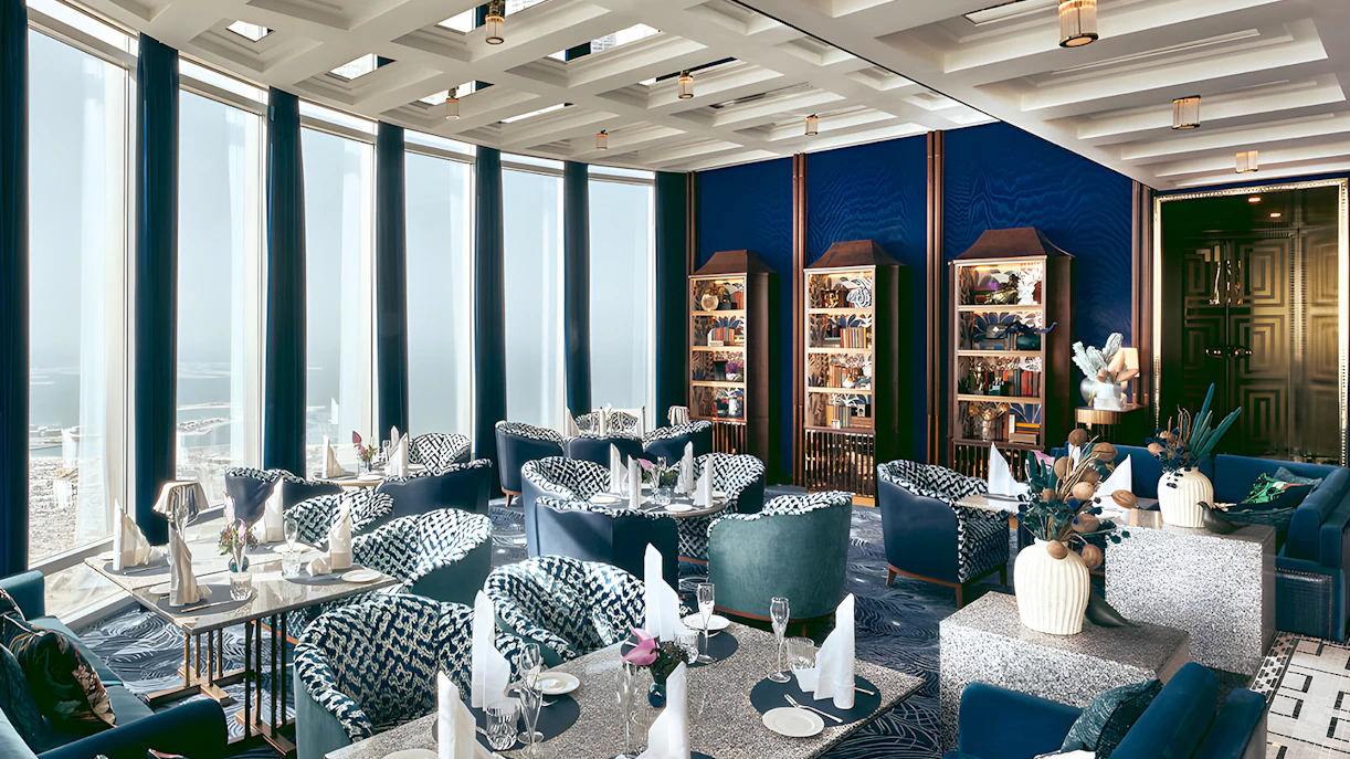 Dining area at At.mosphere Burj Khalifa with elegant seating and panoramic city views.