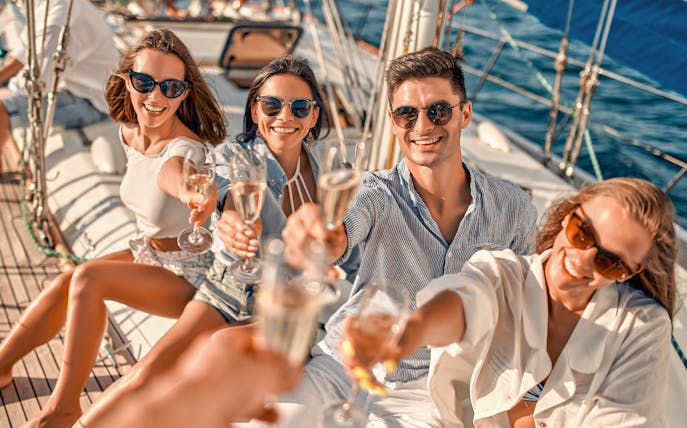 Group enjoying drinks on a sailboat during Metopi, Agistri & Aegina full-day cruise.
