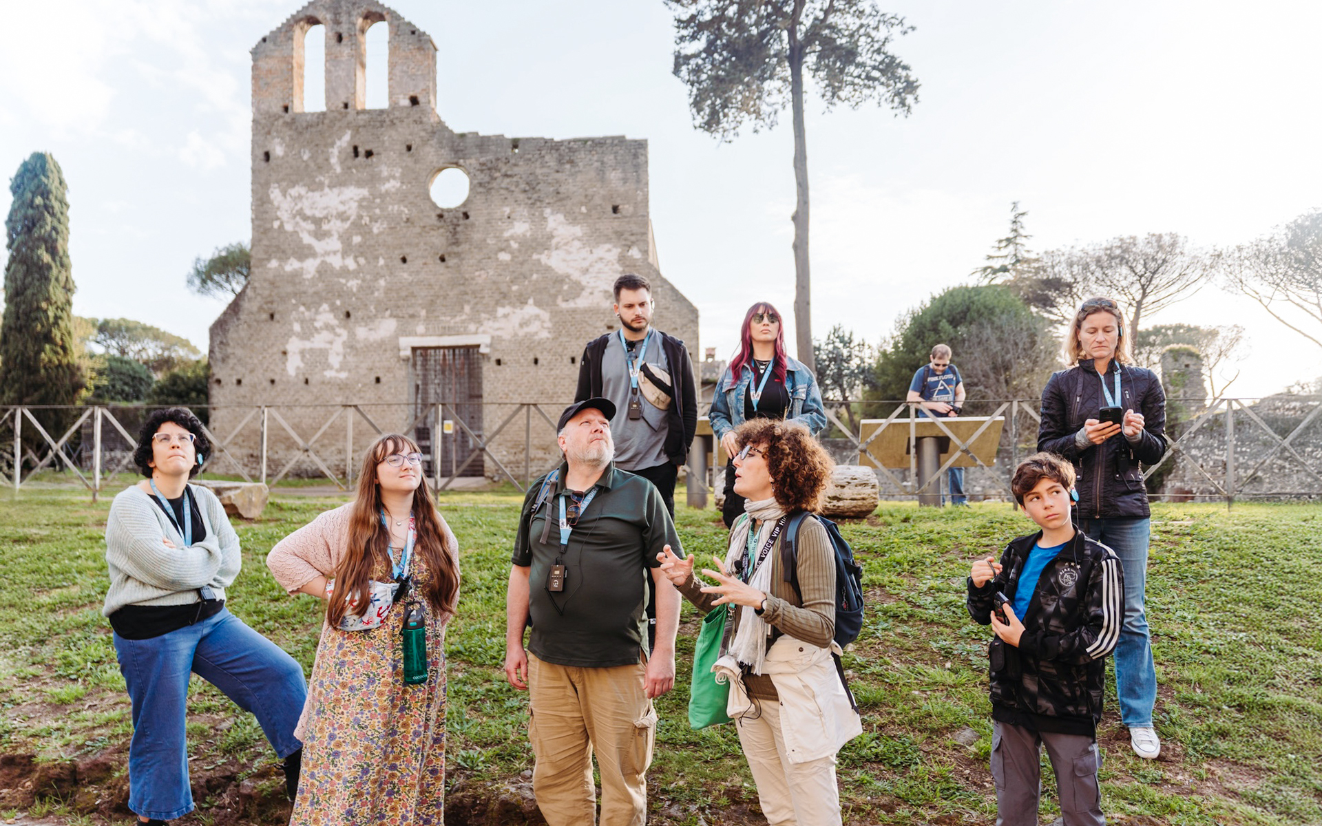 Tour group exploring ancient ruins on the Appian Way during the Underground Rome Catacombs Tour.