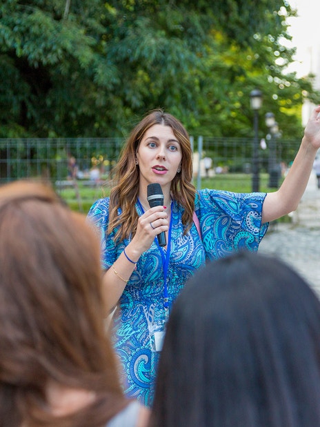 Tour guide speaking to a group at Windsor Castle on a sunny day.