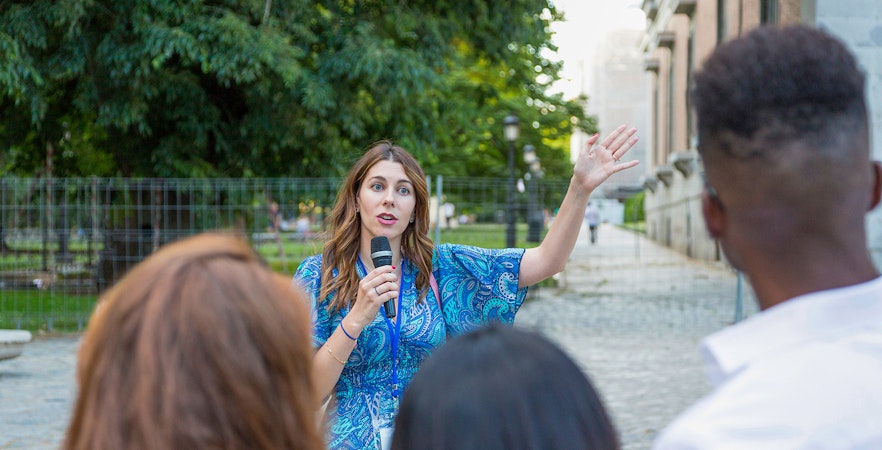 Tour guide speaking to a group at Windsor Castle on a sunny day.