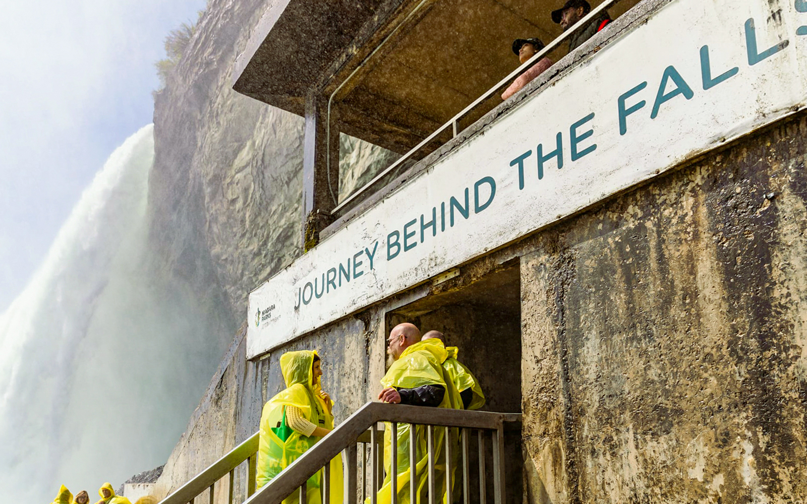 People in yellow ponchos at Journey Behind the Falls, Niagara Falls.