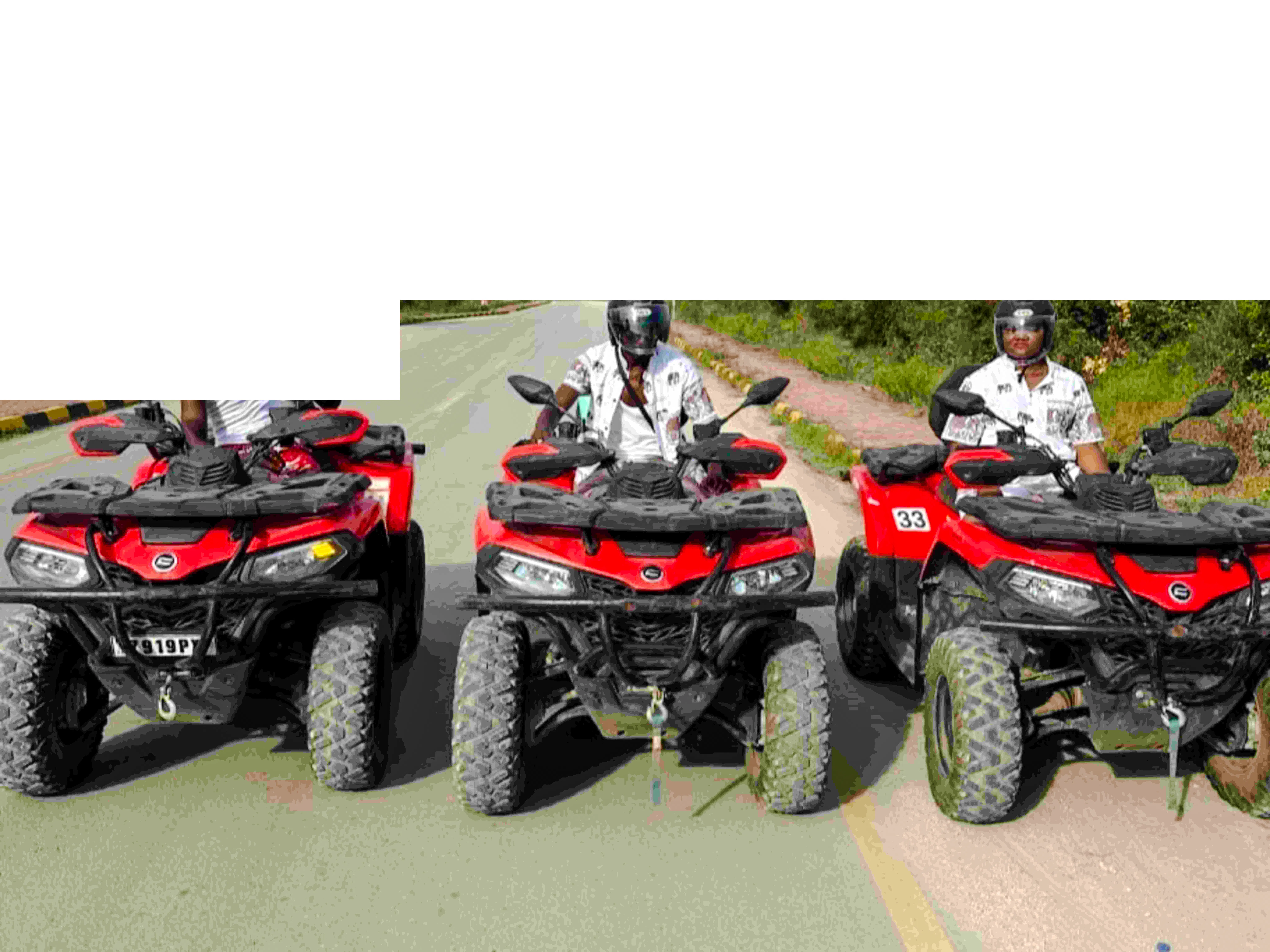 Quad bikes on a scenic road during Zanzibar adventure tour.
