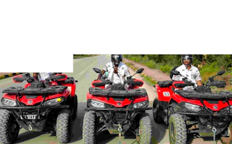 Quad bikes on a scenic road during Zanzibar adventure tour.