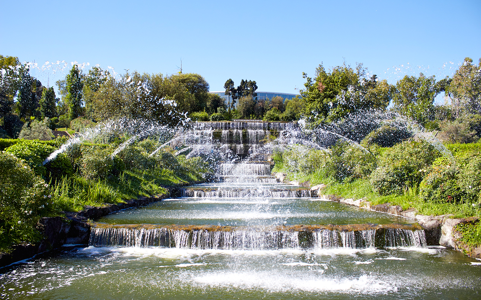 Giardino delle Cascate waterfall with cascading water and surrounding greenery in Rome.