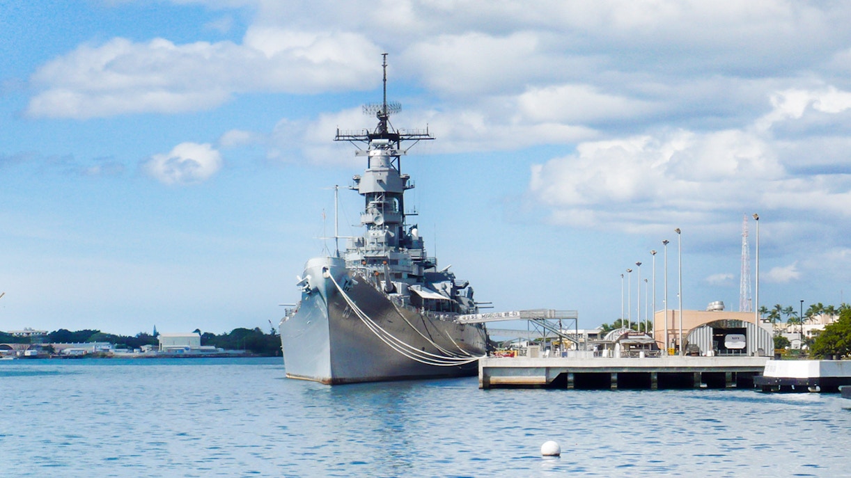 American flags line the walkway to the USS Missouri battleship at Pearl Harbor.