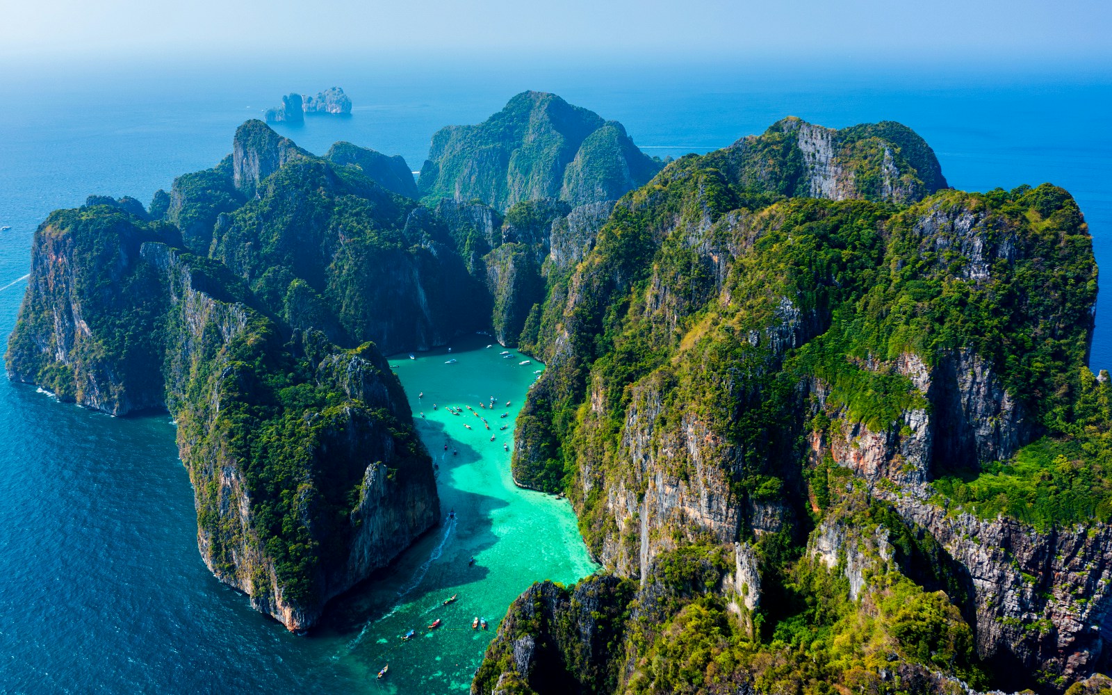 Aerial view of Phi Phi Island's limestone cliffs and turquoise waters, Thailand.