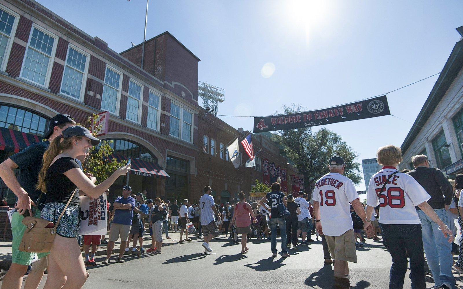 Crowd walking towards Fenway Park entrance in Boston.