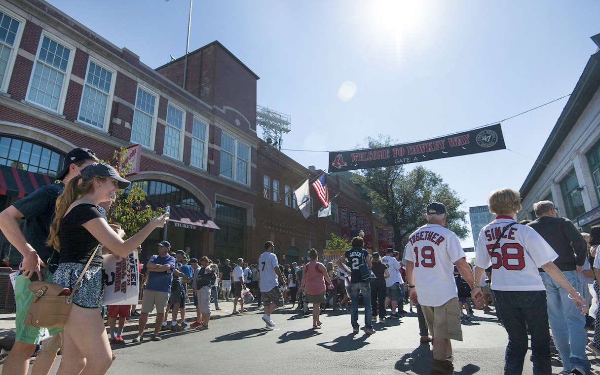 Crowd walking towards Fenway Park entrance in Boston.