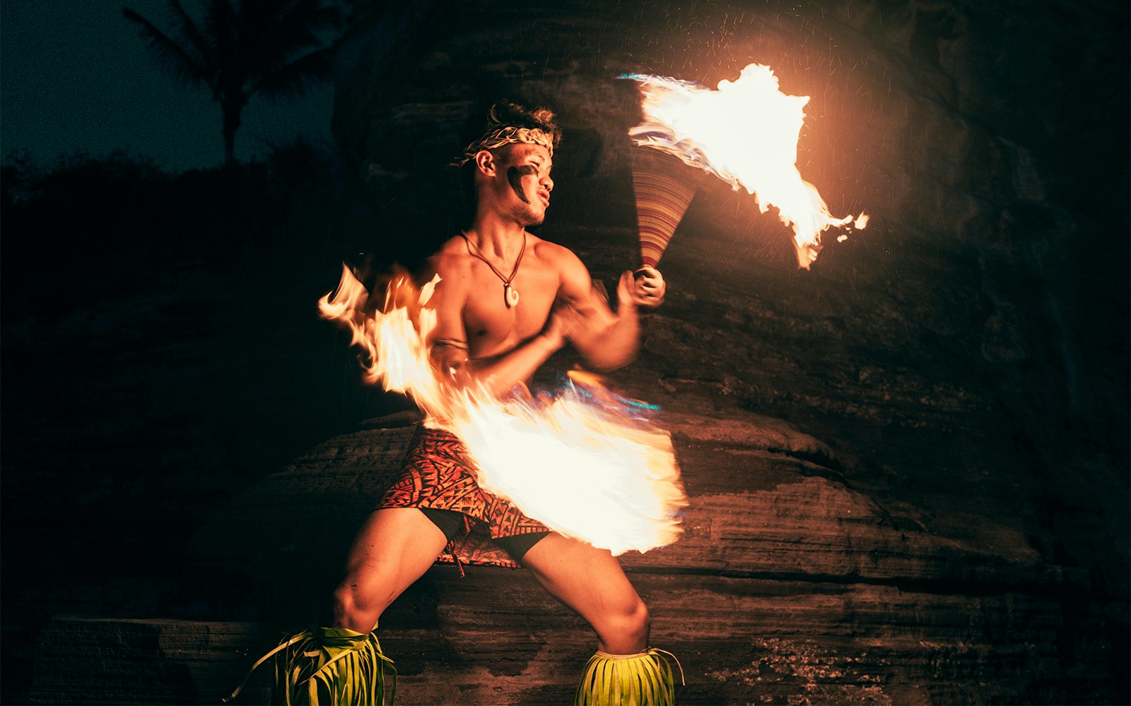 Fire poi performer at Luau Kalamaku cultural show in Hawaii.