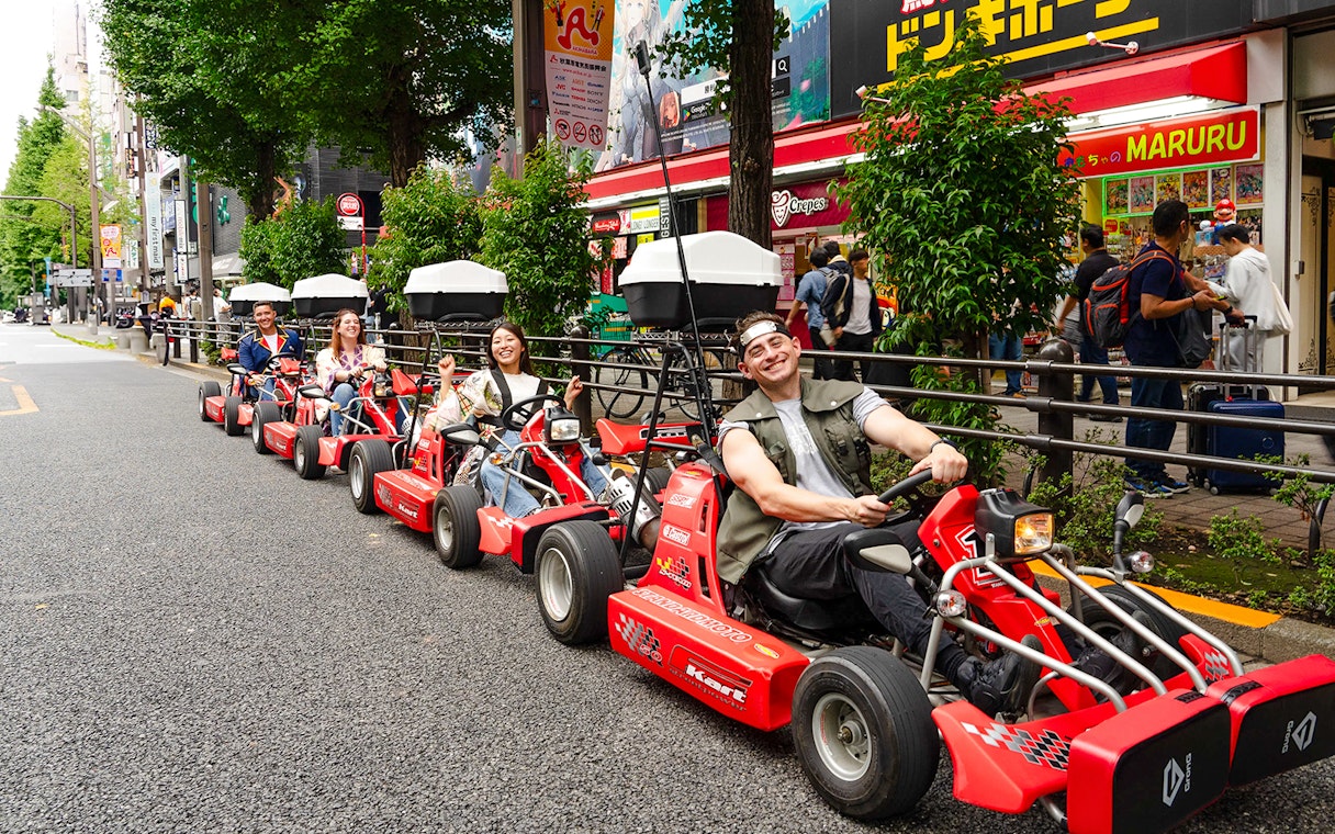 People enjoying Akihabara GoKart experience on a street in Tokyo.