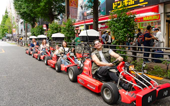 People enjoying Akihabara GoKart experience on a street in Tokyo.
