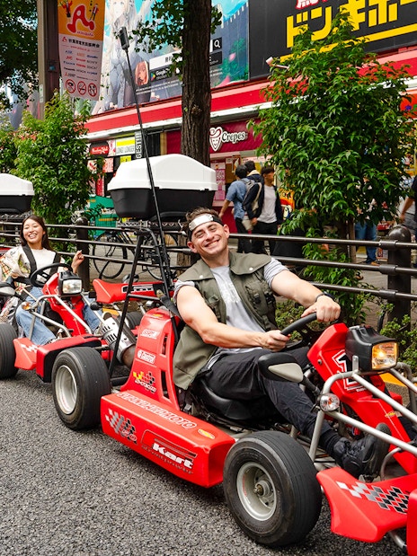 People enjoying Akihabara GoKart experience on a street in Tokyo.
