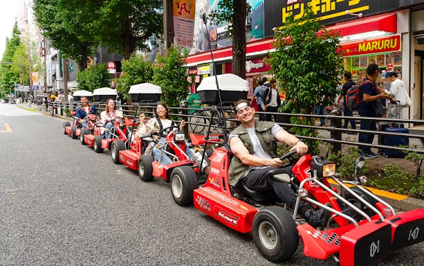 People enjoying Akihabara GoKart experience on a street in Tokyo.