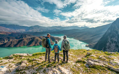 Family hiking on Gamti Mountain overlooking Bovilla Lake.