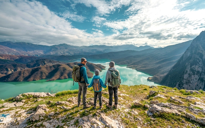 Family hiking on Gamti Mountain overlooking Bovilla Lake.