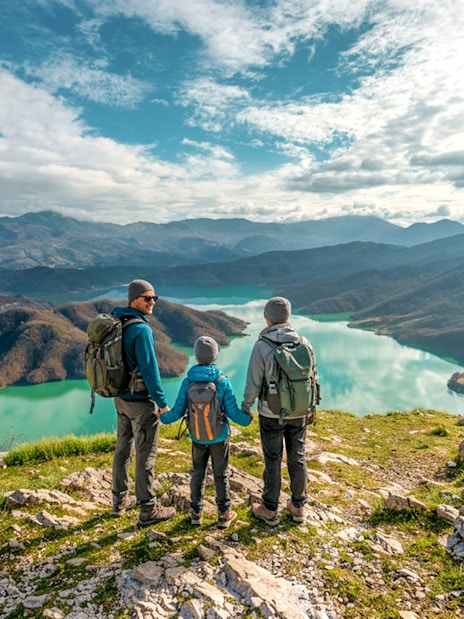 Family hiking on Gamti Mountain overlooking Bovilla Lake.