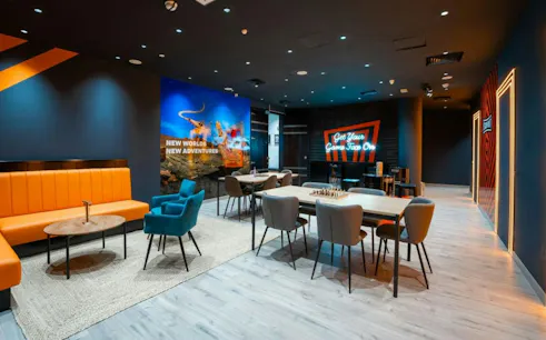 Escape room lobby with seating and neon signs, Dubai.