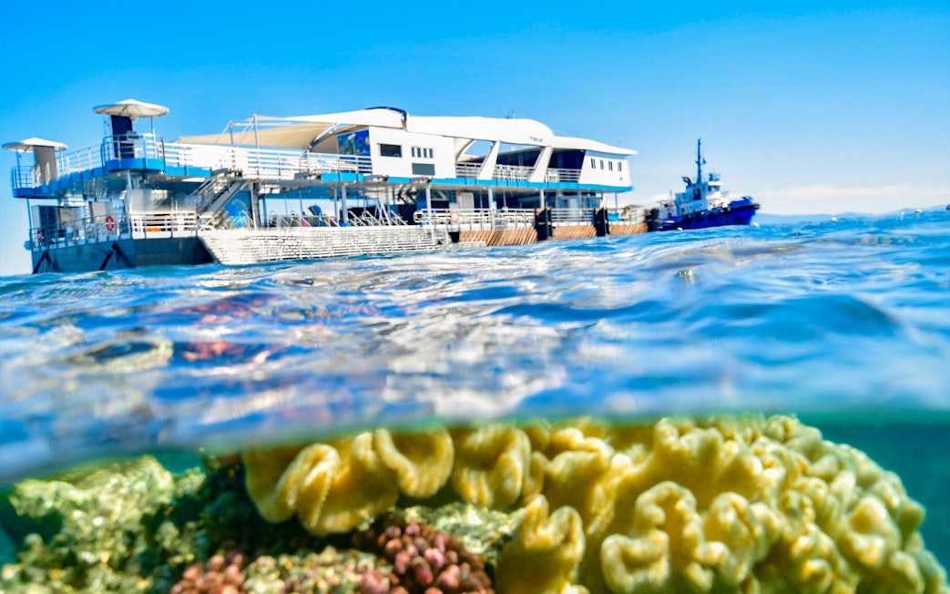 Cruise ship near coral reef in Great Barrier Reef, Cairns.