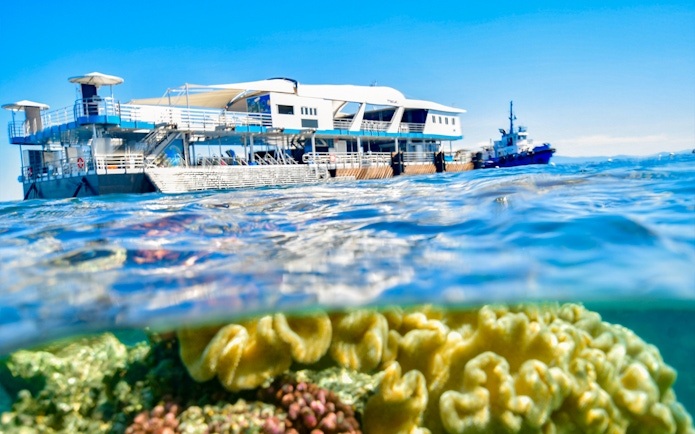 Cruise ship near coral reef in Great Barrier Reef, Cairns.