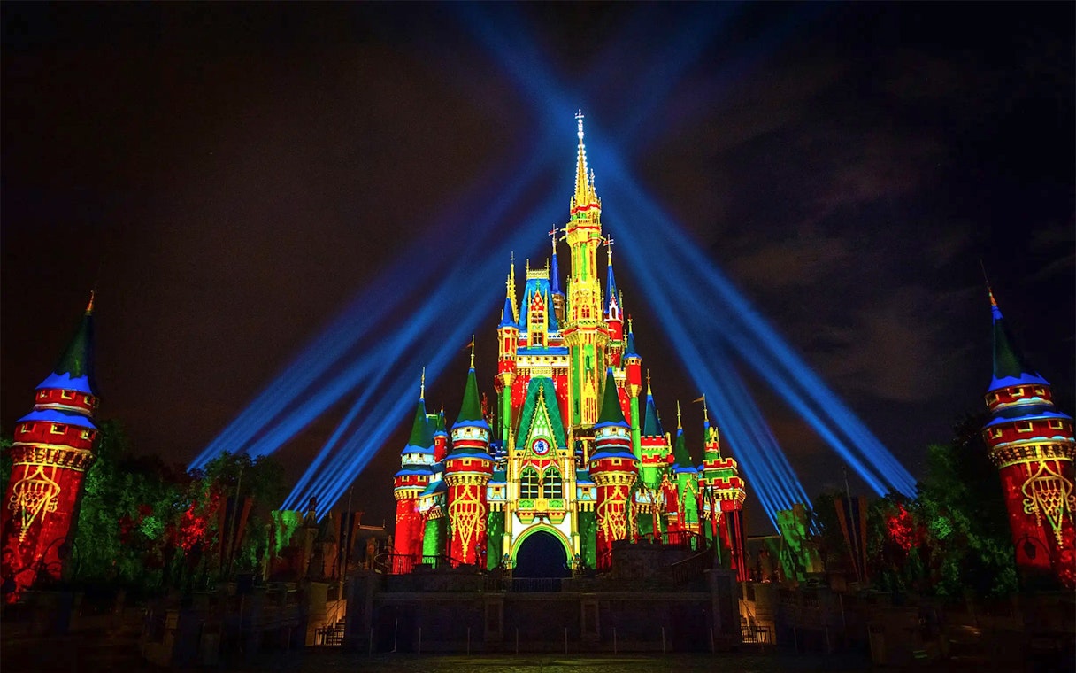 Disney Castle illuminated with lasers during Mickey's Not-So-Scary Halloween Party, Orlando.