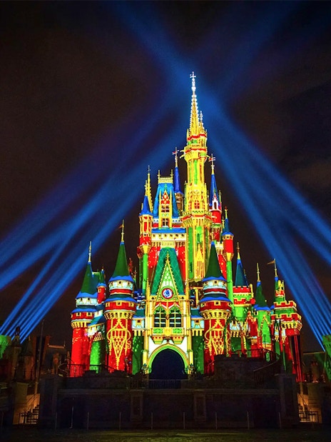 Disney Castle illuminated with lasers during Mickey's Not-So-Scary Halloween Party, Orlando.