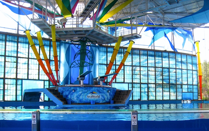 SeaWorld San Antonio dolphin show stage with colorful backdrop and pool.