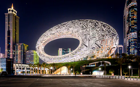 Museum of the Future illuminated at night in Dubai, showcasing its unique architectural design.