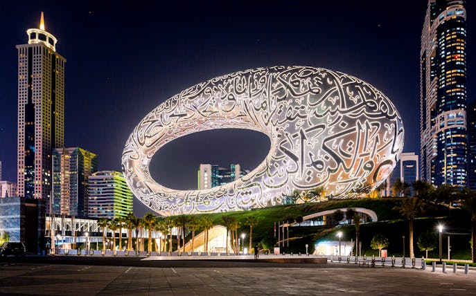 Museum of the Future illuminated at night in Dubai, showcasing its unique architectural design.