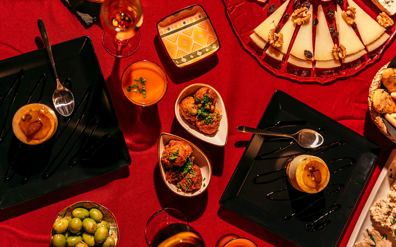Traditional Spanish tapas on a red tablecloth at Laietana Flamenco Show.