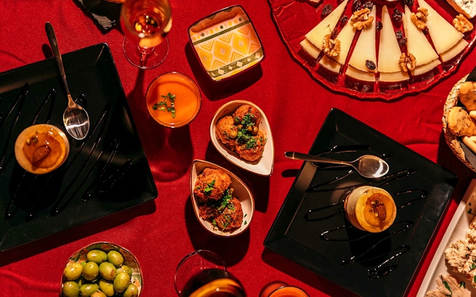 Traditional Spanish tapas on a red tablecloth at Laietana Flamenco Show.