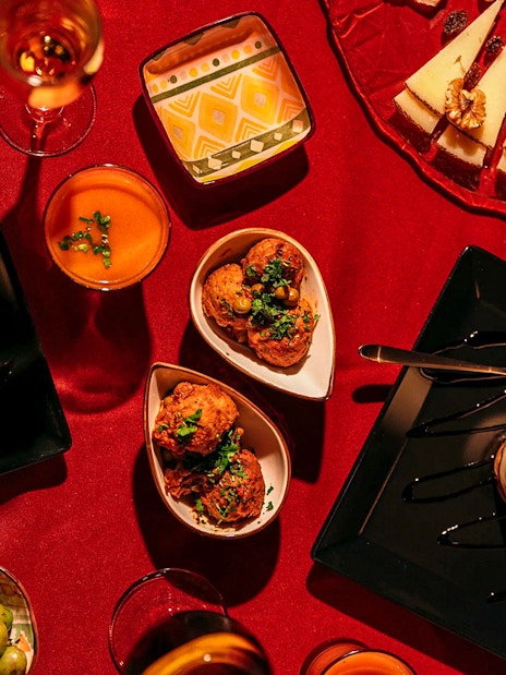Traditional Spanish tapas on a red tablecloth at Laietana Flamenco Show.