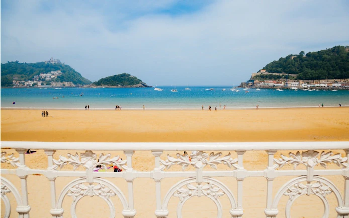 La Concha Beach view with ornate railing in San Sebastian, Spain.