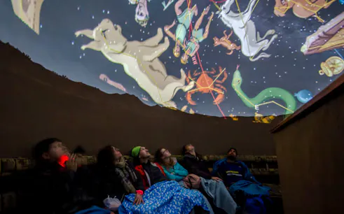 Visitors watching a constellation show at Cusco Planetarium, Peru.