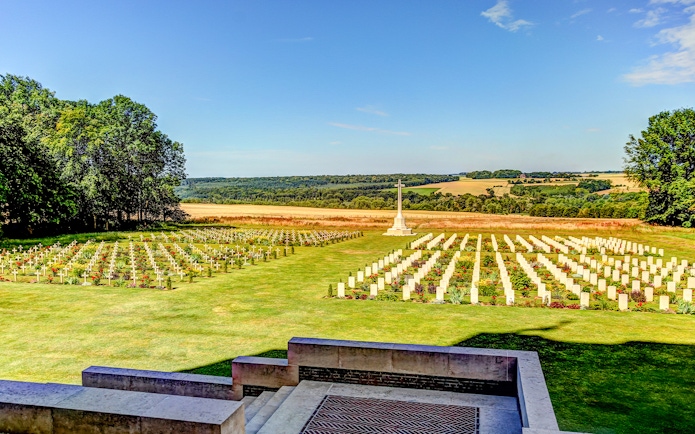 Somme battlefield cemetery with rows of white crosses and a memorial, France.