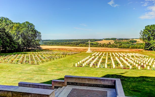 Somme battlefield cemetery with rows of white crosses and a memorial, France.