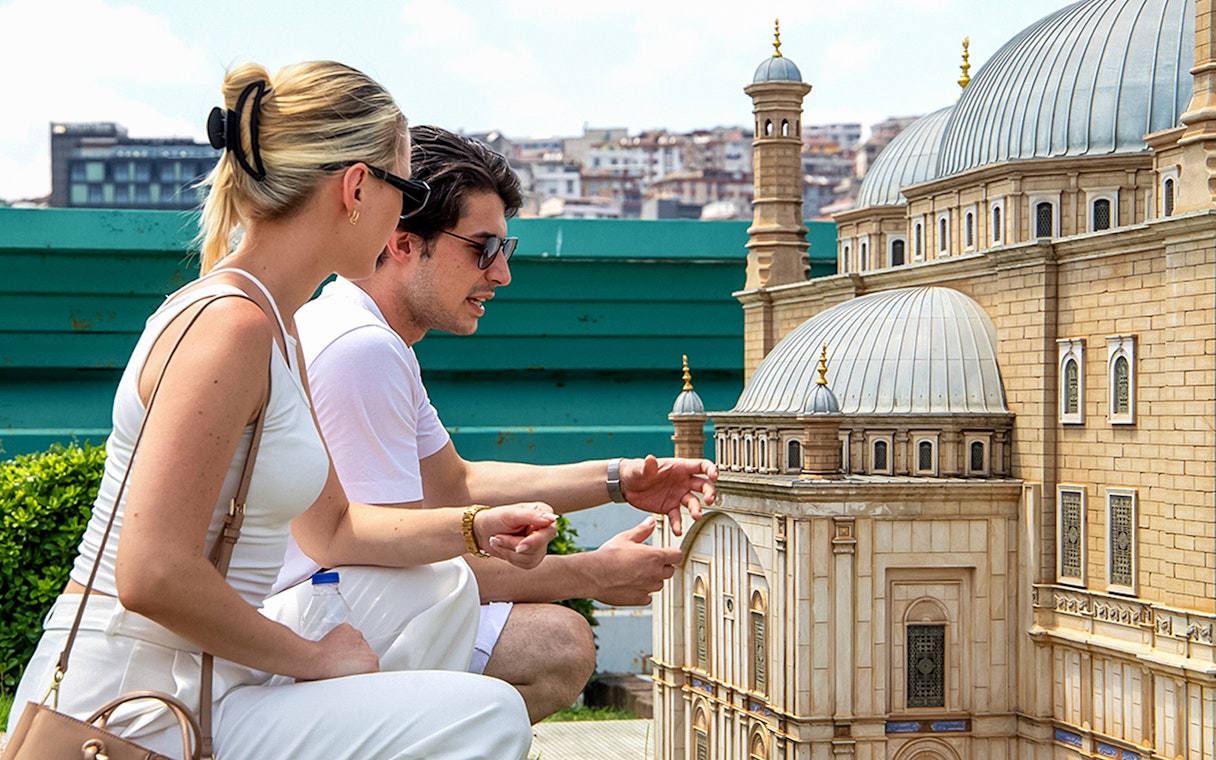 Guests examining a miniature model at Istanbul Miniatürk.