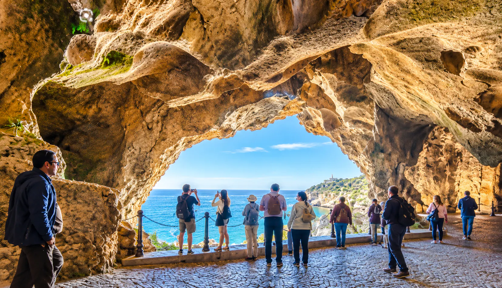 Visitors exploring Hercules Caves with ocean view, Cape Spartel, Tangier.