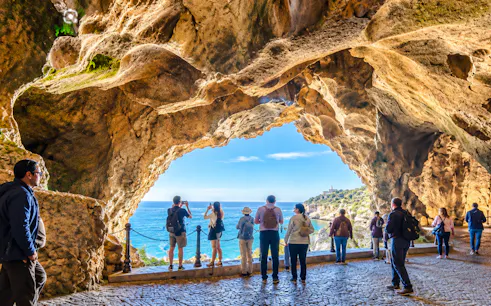 Visitors exploring Hercules Caves with ocean view, Cape Spartel, Tangier.