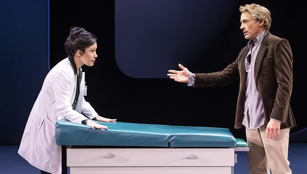 Doctor and patient in discussion at a medical examination table, McNEAL.