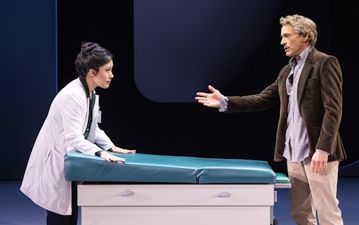 Doctor and patient in discussion at a medical examination table, McNEAL.