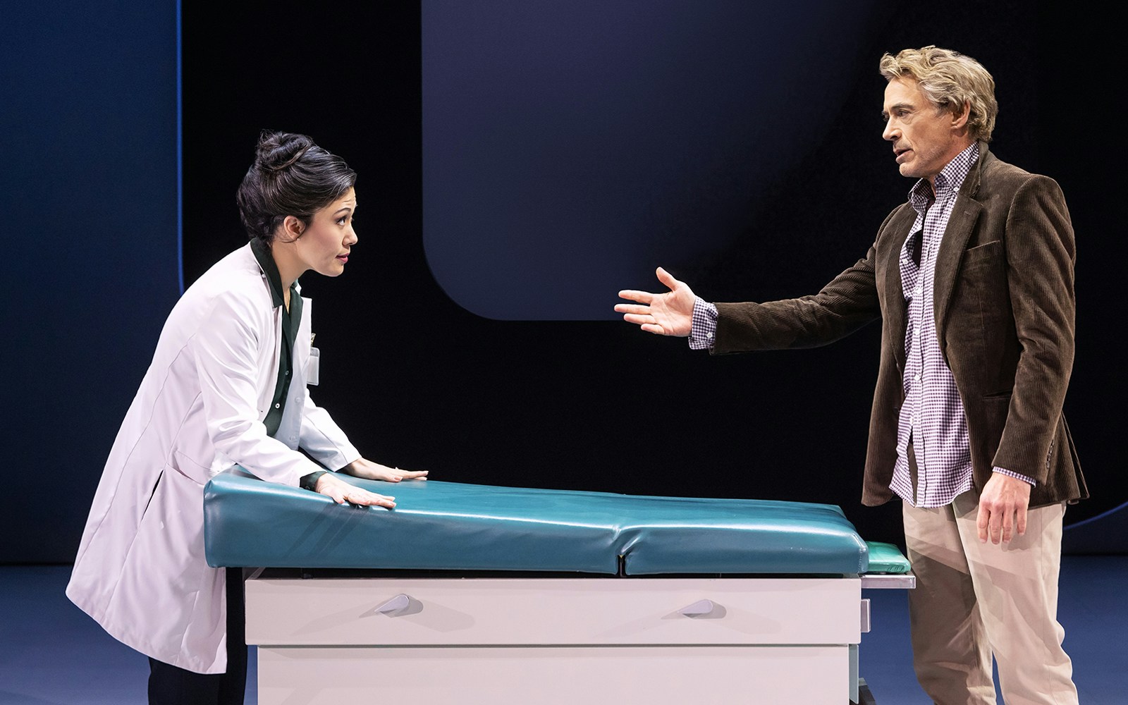 Doctor and patient in discussion at a medical examination table, McNEAL.
