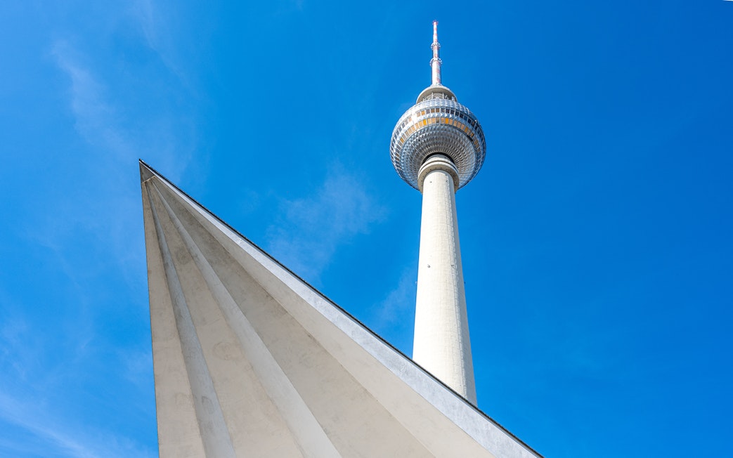 Berlin TV Tower against a clear blue sky.