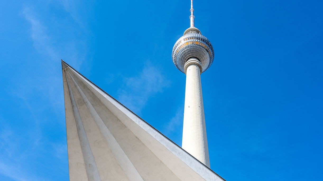 Berlin TV Tower against a clear blue sky.