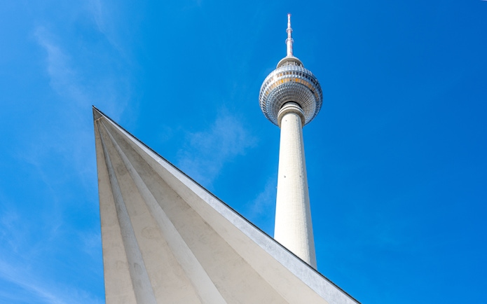 Berlin TV Tower against a clear blue sky.