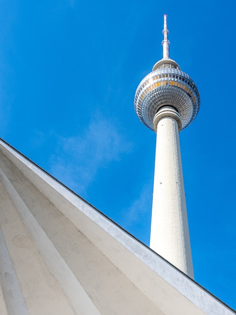 Berlin TV Tower against a clear blue sky.