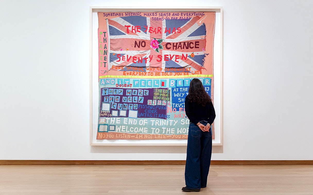 Visitor viewing Tracey Emin's "No Chance" exhibit at Stedelijk Museum.